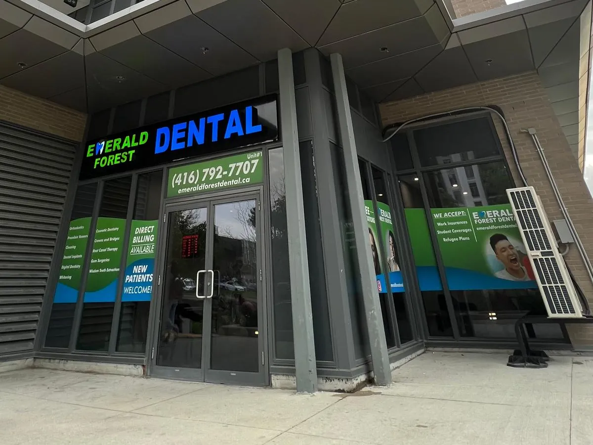 Entrance to Emerald Forest Dental Clinic, Unit 1 at 56 Forest Manor Rd, North York, with the clinic sign above the glass doors