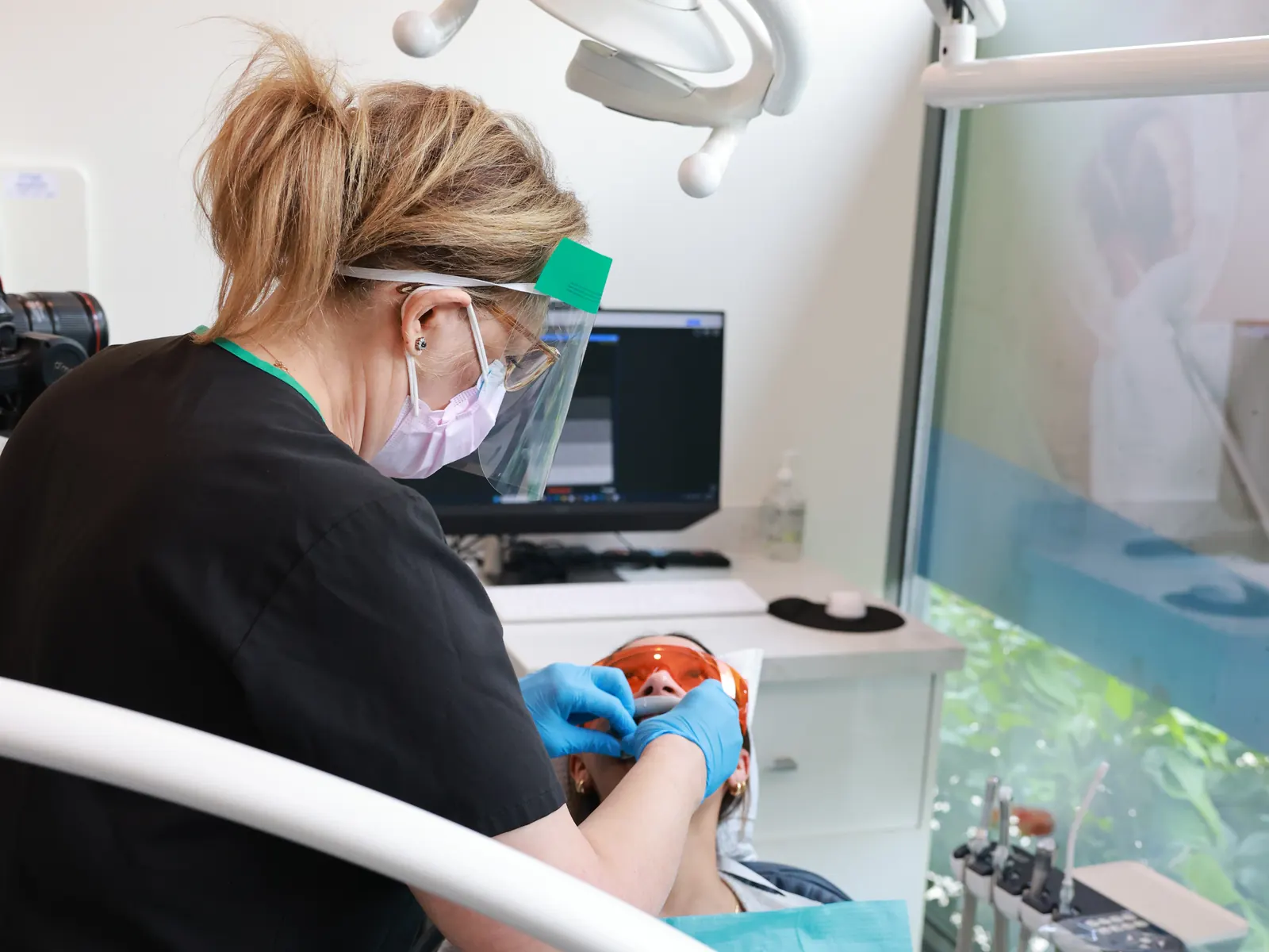 Hygienist checking a patient's gums and teeth during a periodontal maintenance visit