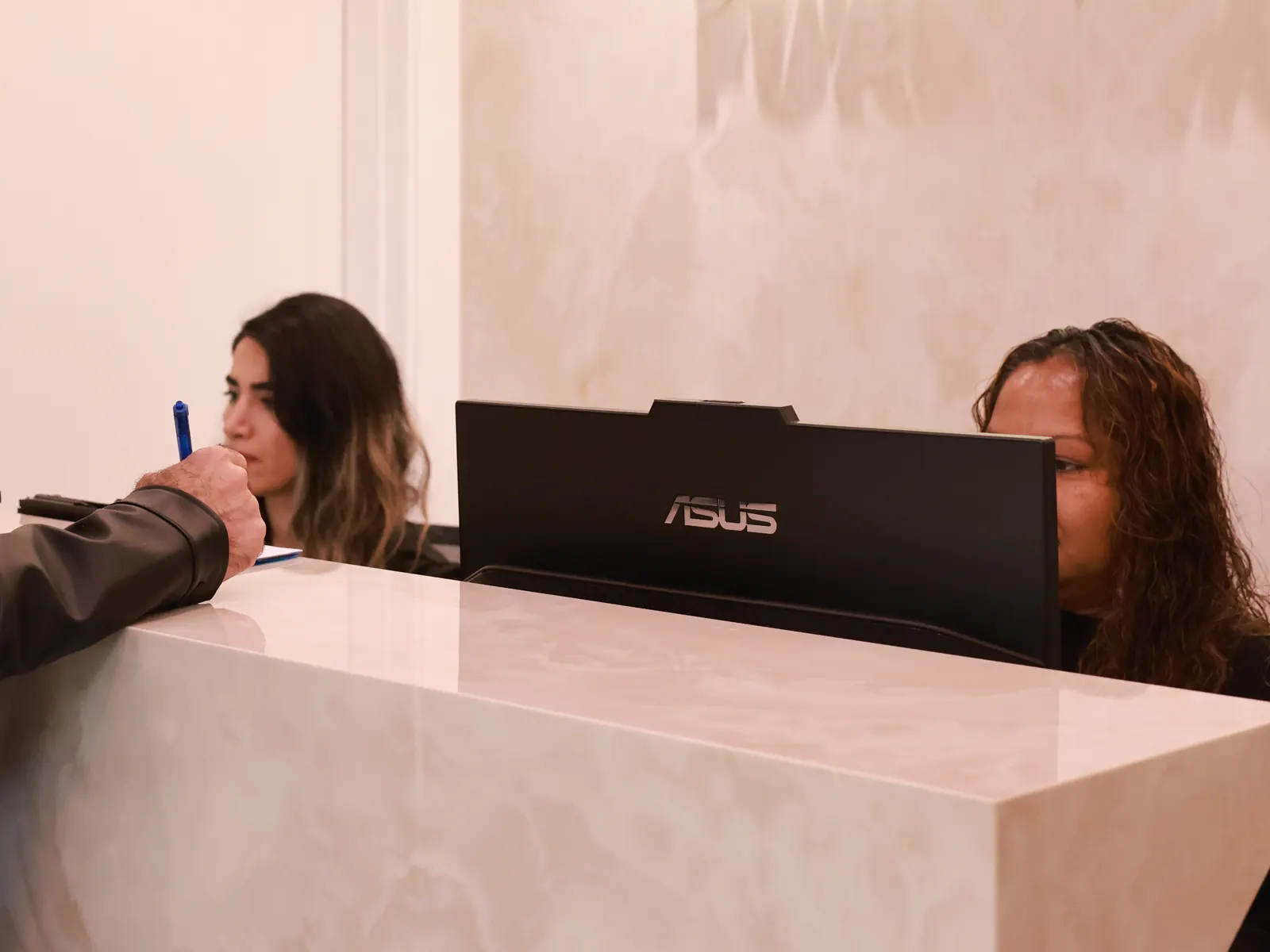 Front desk team helping a patient at Emerald Forest Dental Clinic in North York